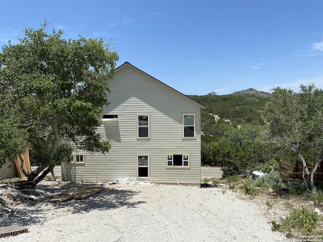 back of house with a mountain view
