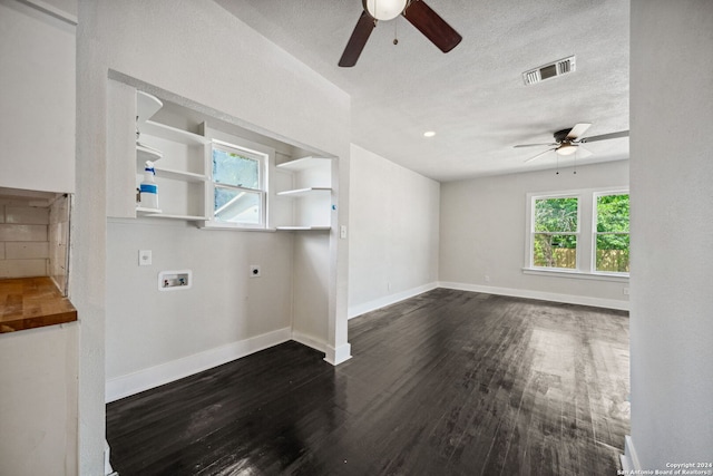 unfurnished living room featuring ceiling fan, dark hardwood / wood-style floors, and a textured ceiling