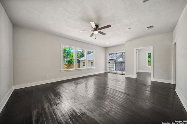 unfurnished living room with ceiling fan, a textured ceiling, and dark wood-type flooring