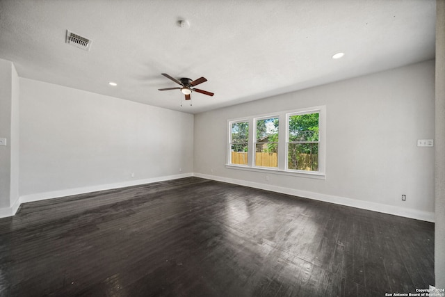 empty room featuring dark wood-type flooring and ceiling fan