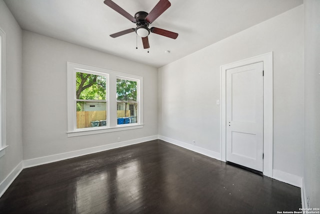 spare room with ceiling fan and dark hardwood / wood-style floors