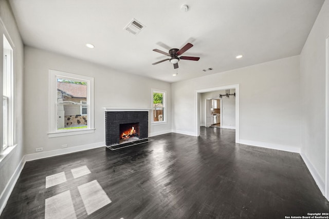 unfurnished living room with dark wood-type flooring and ceiling fan