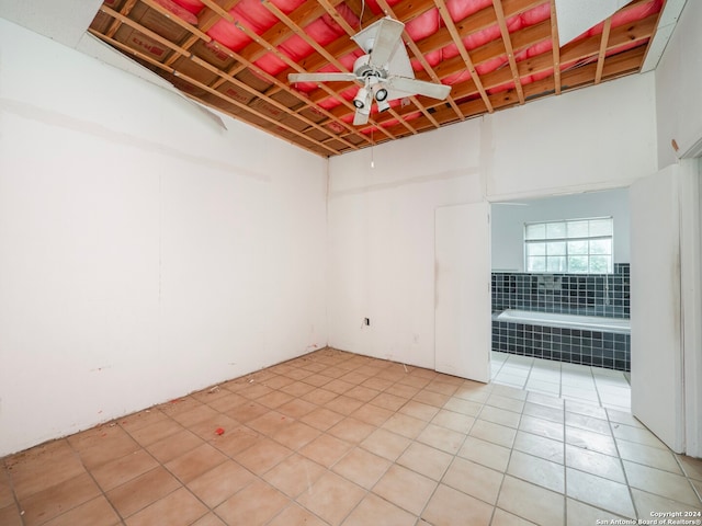 empty room featuring light tile patterned floors and ceiling fan