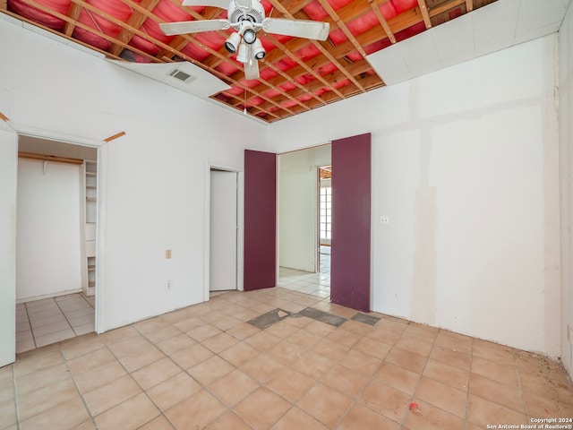 unfurnished bedroom with ceiling fan and light tile patterned floors