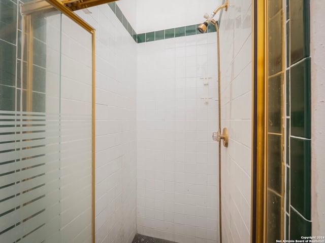 bathroom with a shower with door