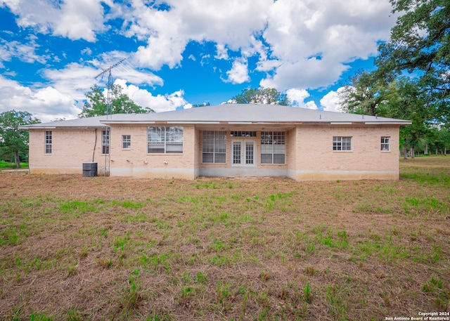 rear view of house featuring french doors, central AC, and a patio area