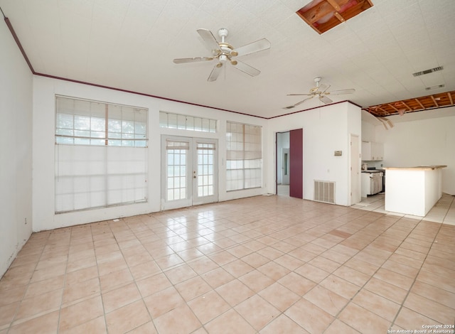 unfurnished living room with ceiling fan, light tile patterned flooring, and french doors