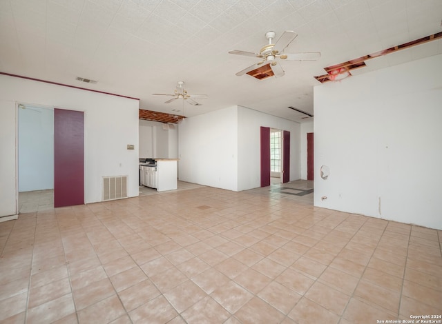 unfurnished room featuring ceiling fan and light tile patterned flooring