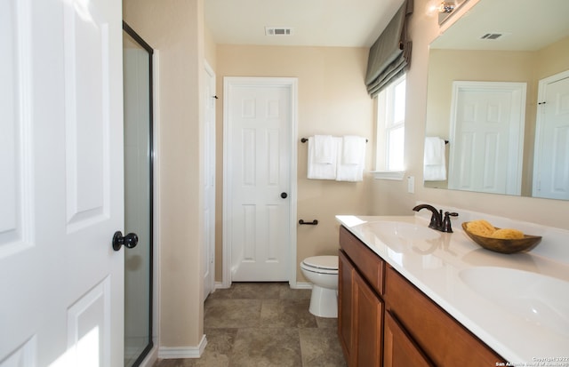 bathroom with walk in shower, vanity, toilet, and tile patterned floors