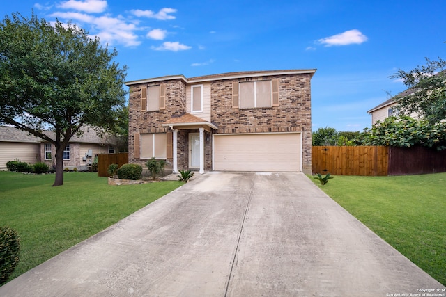 view of property featuring a front yard and a garage