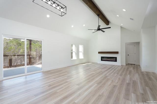 unfurnished living room with light hardwood / wood-style flooring, ceiling fan, high vaulted ceiling, and a wealth of natural light