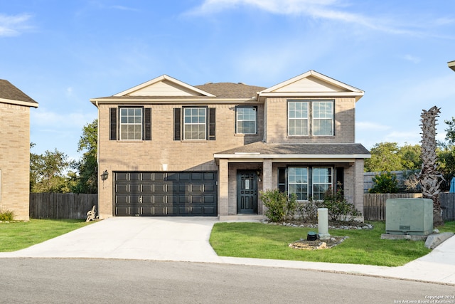 view of front of house featuring a garage and a front lawn