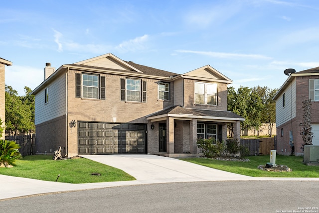 view of front of home featuring a garage, a front lawn, and central AC