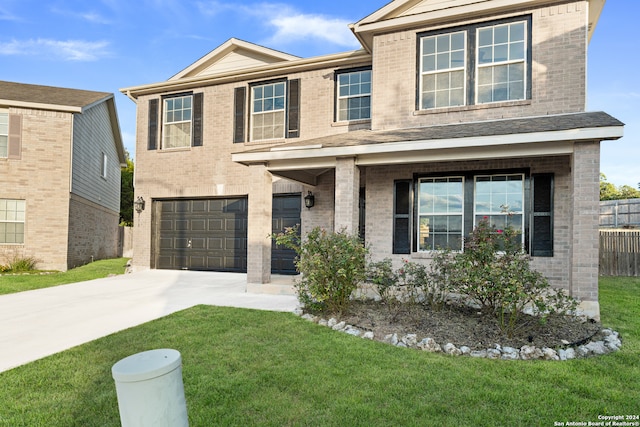 view of front of property featuring a garage and a front lawn