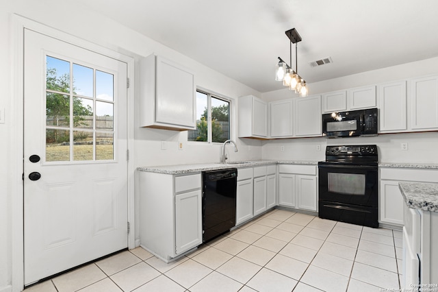 kitchen with pendant lighting, white cabinets, black appliances, and a wealth of natural light