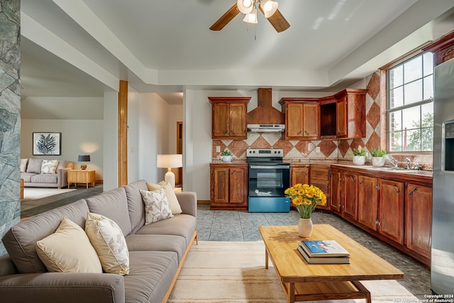 living room with ceiling fan, light tile patterned floors, and sink