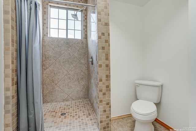 bathroom with tile patterned flooring, toilet, and a shower with shower curtain