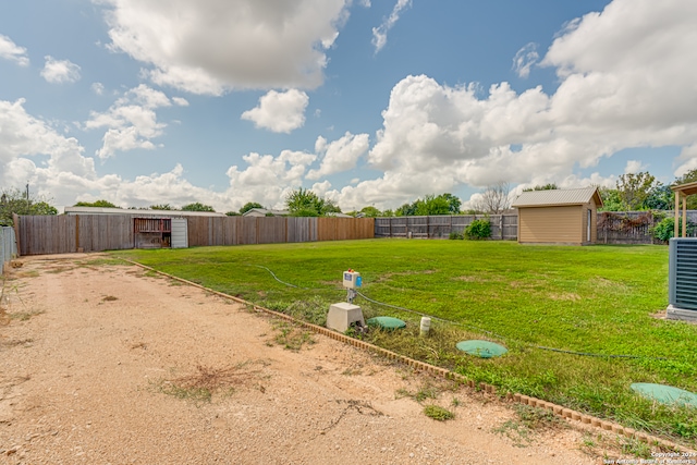 view of yard with a storage unit and cooling unit