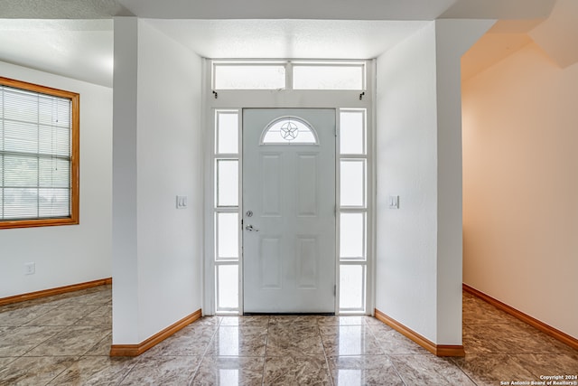 foyer with a textured ceiling