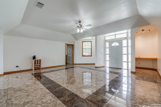 empty room with ceiling fan and a textured ceiling