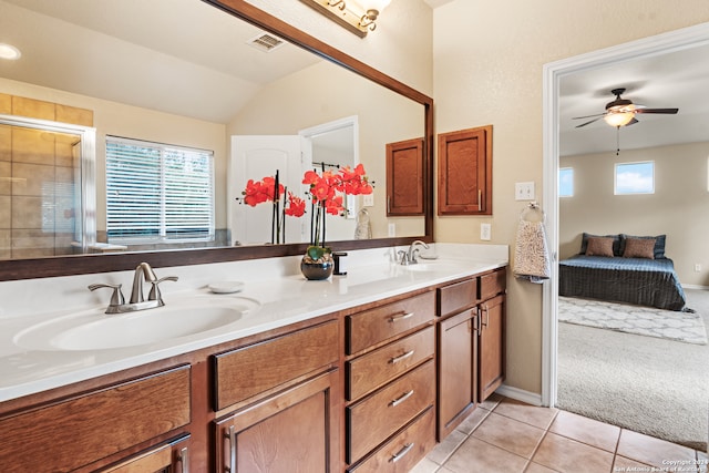 bathroom with ceiling fan, vanity, lofted ceiling, an enclosed shower, and tile patterned floors