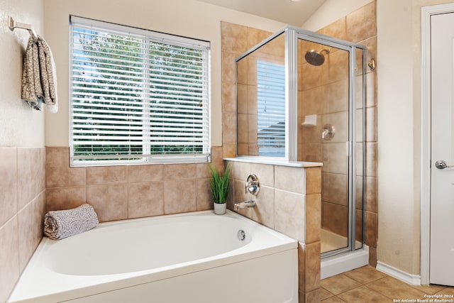 bathroom with a healthy amount of sunlight, tile patterned flooring, lofted ceiling, and shower with separate bathtub