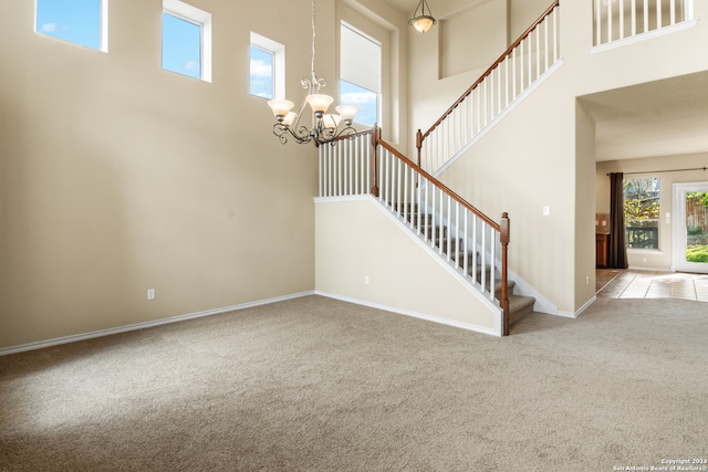 interior space with a high ceiling and carpet flooring