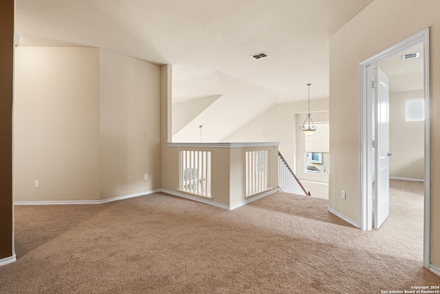 interior space with vaulted ceiling and carpet flooring