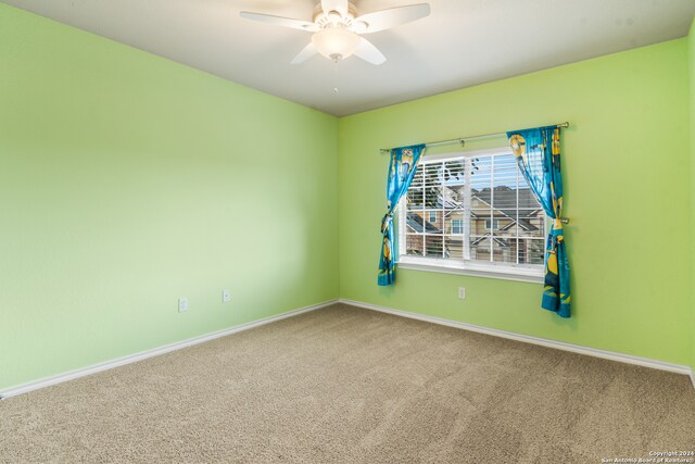 carpeted empty room with ceiling fan