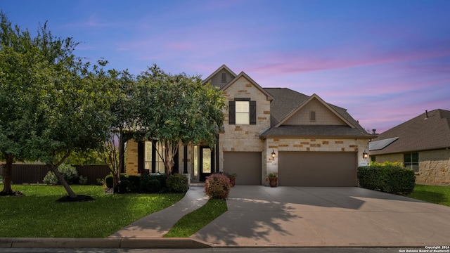 view of front of property with a yard and a garage