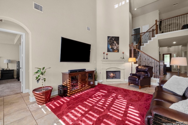 living room with a high ceiling and light tile patterned floors