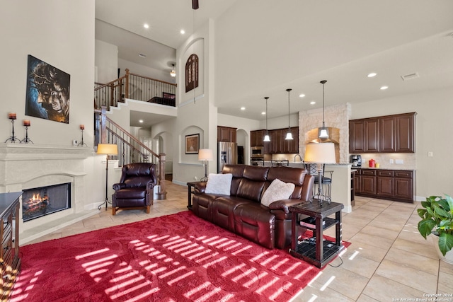 tiled living room with a towering ceiling