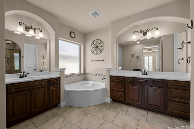 bathroom with a bathing tub, tile patterned flooring, vanity, and ceiling fan