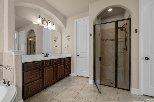 bathroom with plus walk in shower, tile patterned flooring, and vanity