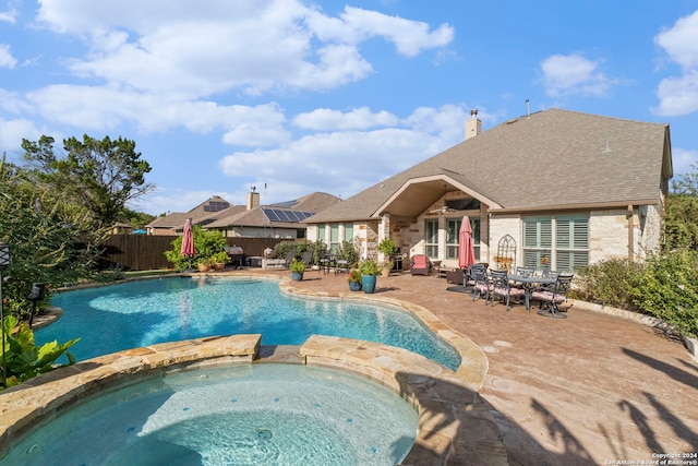 view of pool with an in ground hot tub and a patio area