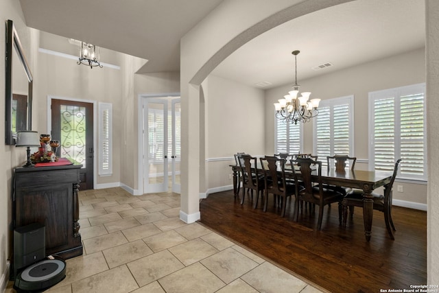 interior space featuring an inviting chandelier and light hardwood / wood-style flooring