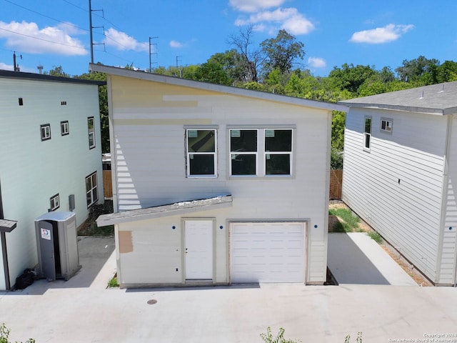 rear view of property with a garage