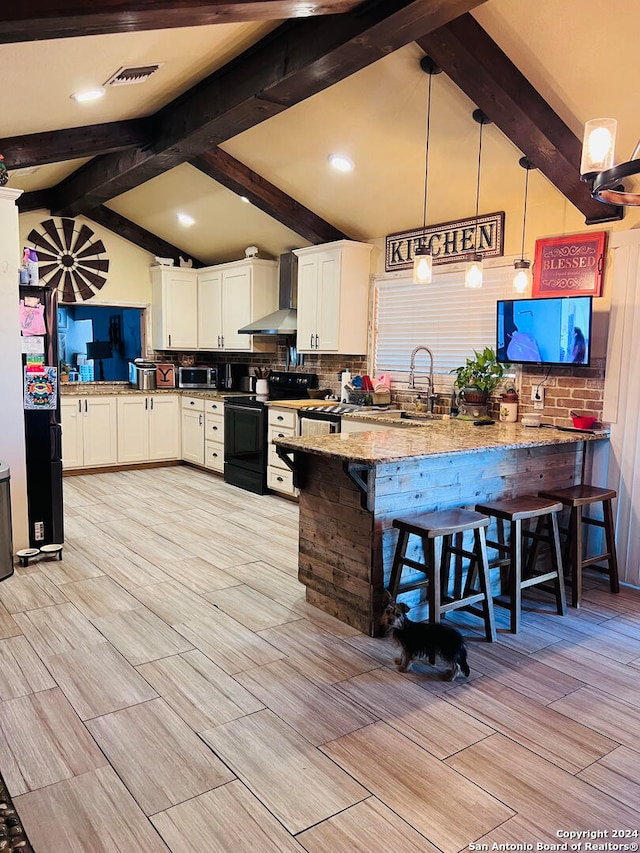 kitchen with black electric range, a kitchen bar, kitchen peninsula, pendant lighting, and white cabinets