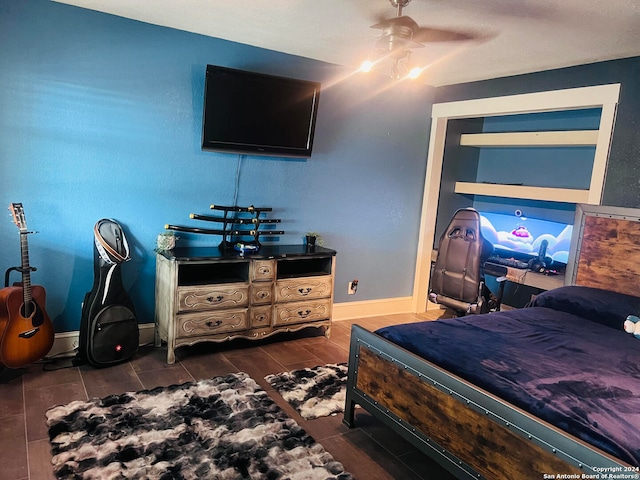 bedroom with dark hardwood / wood-style floors and ceiling fan