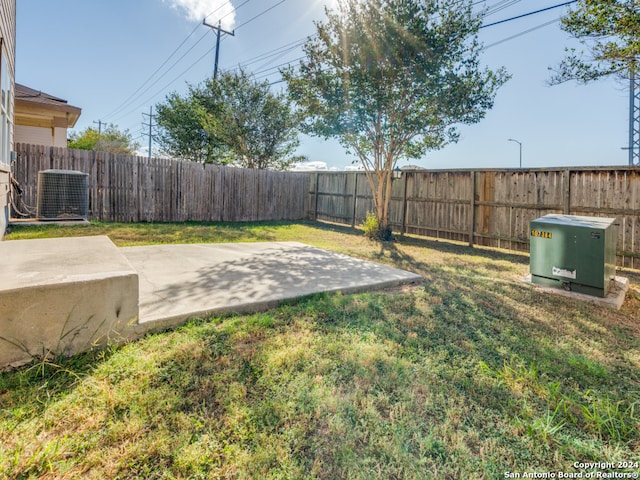 view of yard featuring cooling unit and a patio area