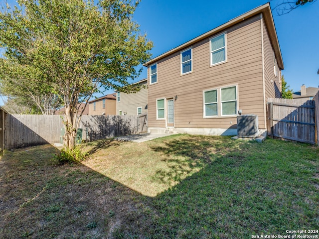rear view of house featuring a patio area and a lawn