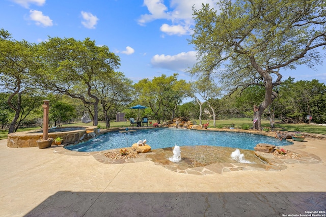 view of swimming pool with a patio, an in ground hot tub, and pool water feature