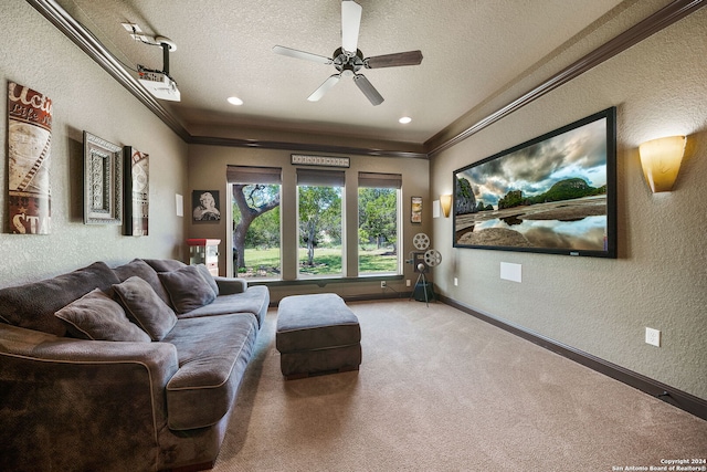 carpeted living room featuring a textured ceiling, ornamental molding, and ceiling fan