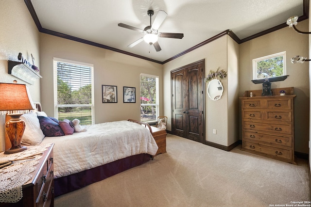 carpeted bedroom featuring ceiling fan, a textured ceiling, a closet, and ornamental molding