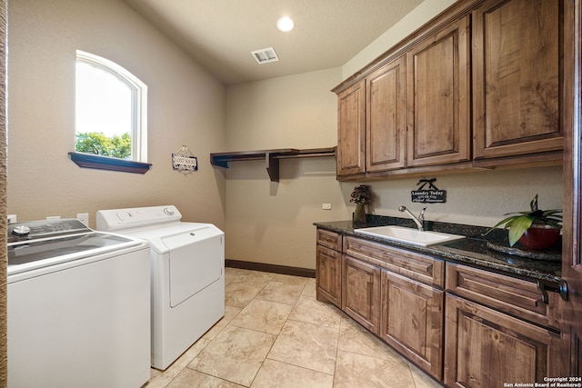 washroom featuring cabinets, washer and clothes dryer, and sink