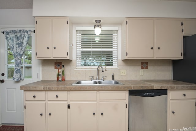 kitchen featuring white cabinetry, dishwasher, sink, decorative backsplash, and plenty of natural light