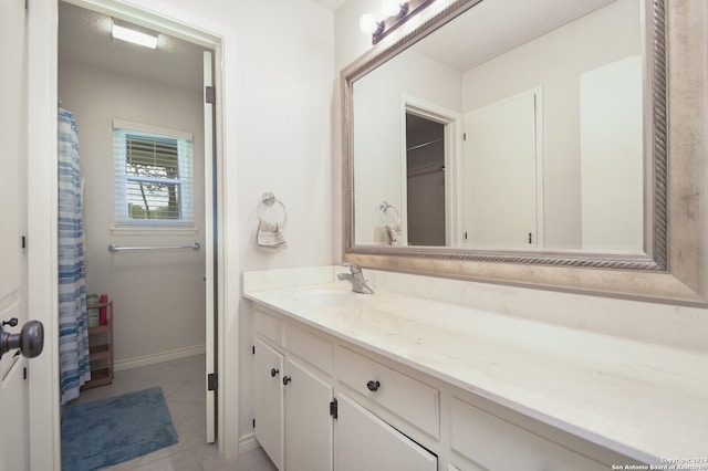 bathroom with tile patterned floors and vanity