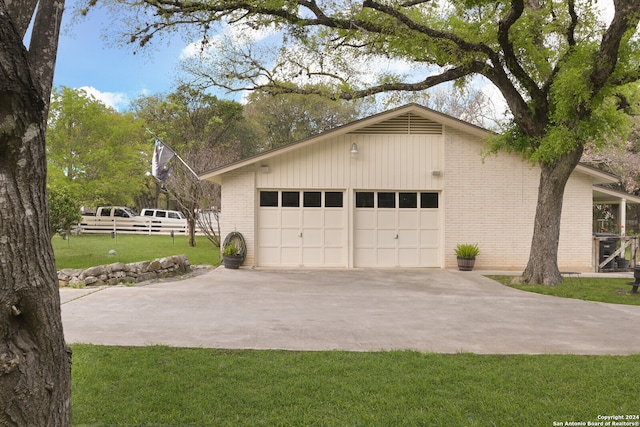 garage featuring a lawn