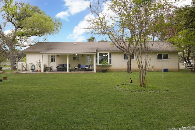 back of house with a yard and a patio area