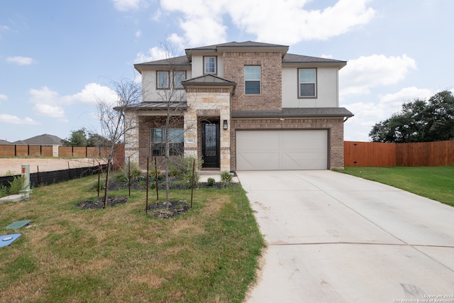 view of front facade with a front yard and a garage